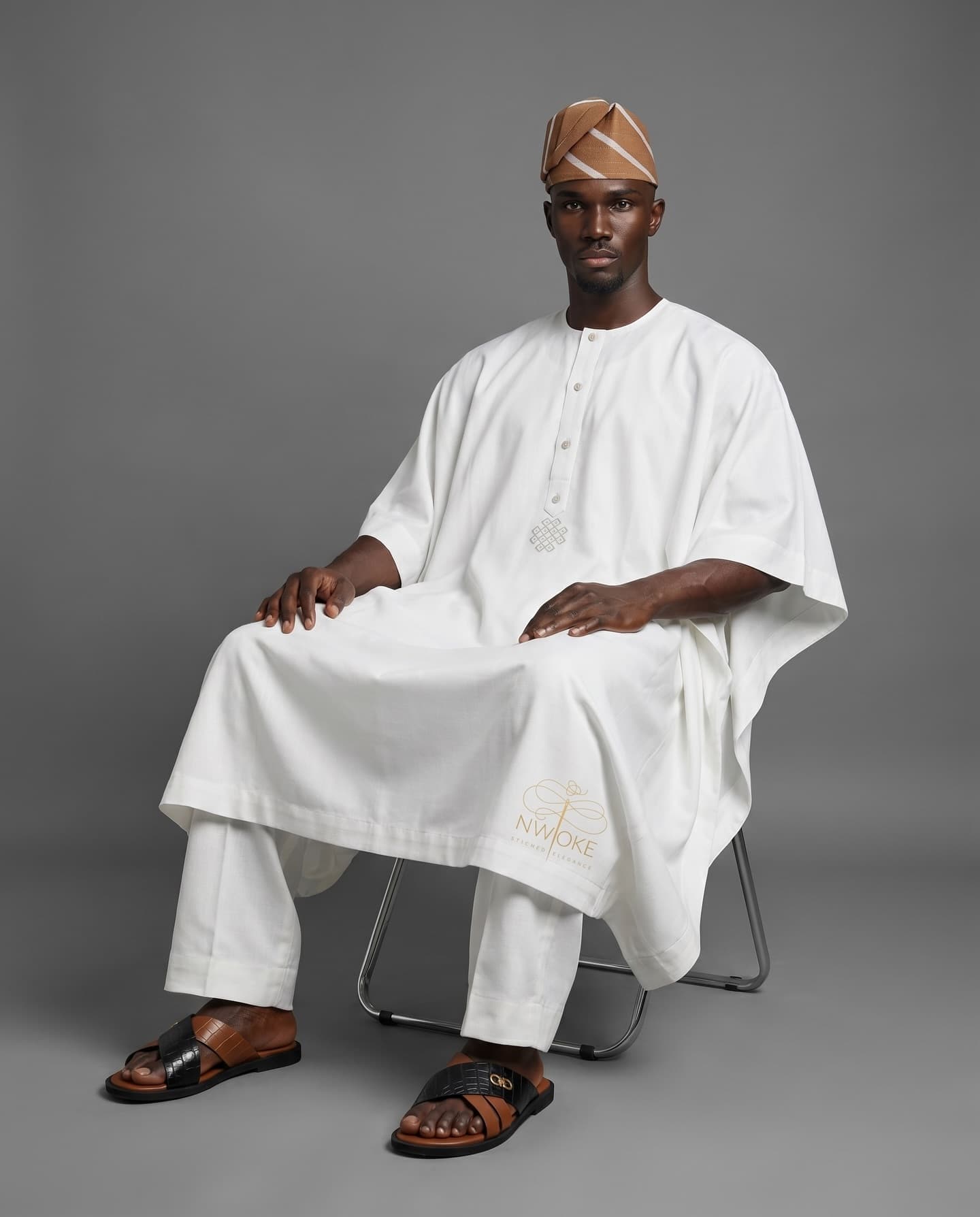 A model seated in the Ivory Kaftan with a patterned fila